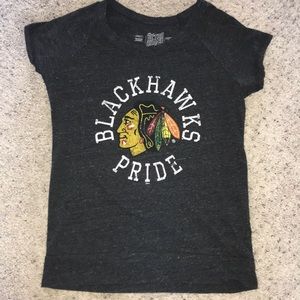 A shirt that have the Blackhawks logo on it.